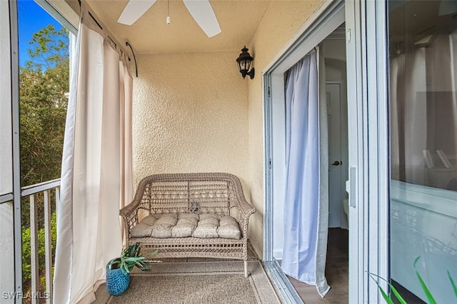 sunroom / solarium featuring ceiling fan