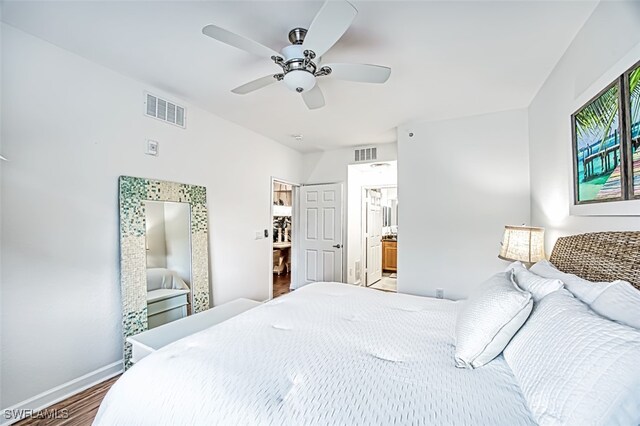 bedroom featuring ensuite bathroom, hardwood / wood-style flooring, and ceiling fan