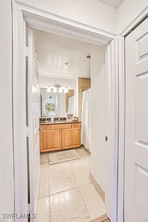 bathroom with vanity, a shower with shower curtain, and tile patterned flooring