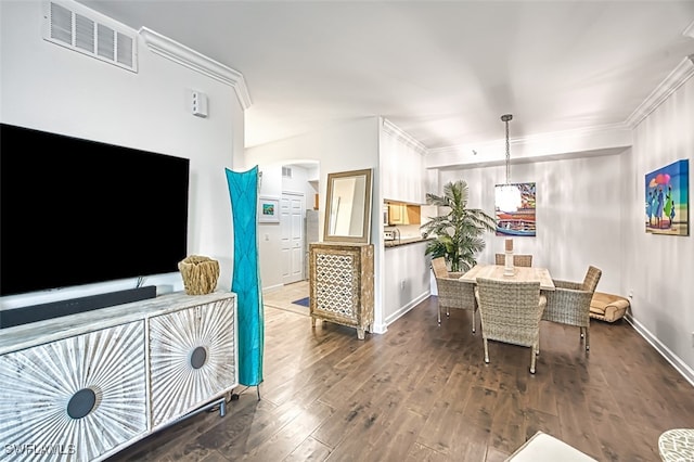 dining space with crown molding and dark hardwood / wood-style floors