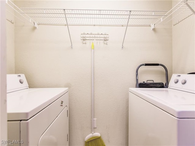 clothes washing area featuring independent washer and dryer