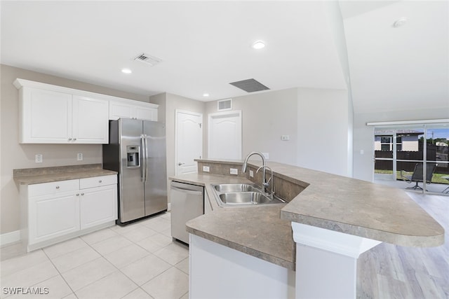 kitchen featuring white cabinetry, sink, an island with sink, and stainless steel appliances