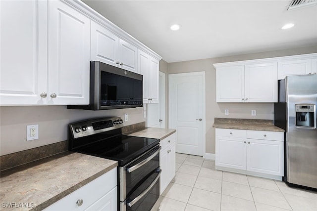 kitchen featuring white cabinets, light tile patterned floors, and appliances with stainless steel finishes