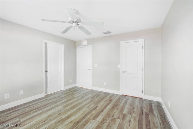 unfurnished room with ceiling fan and light wood-type flooring