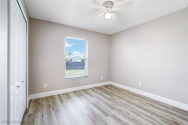 unfurnished bedroom featuring ceiling fan, light hardwood / wood-style flooring, and a closet