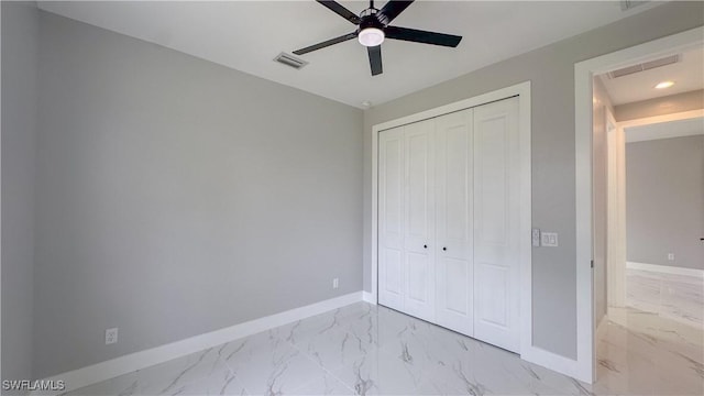 unfurnished bedroom with ceiling fan and a closet