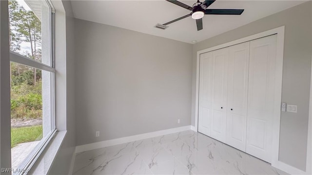 unfurnished bedroom featuring multiple windows, a closet, and ceiling fan