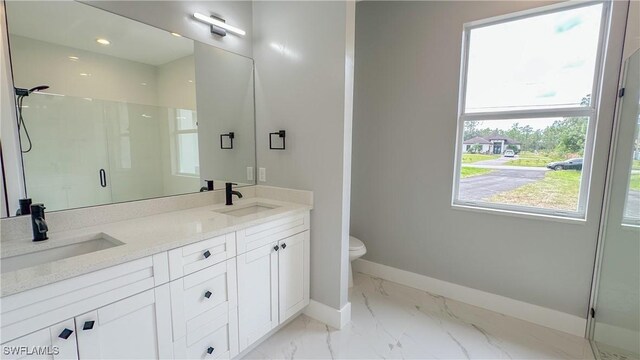 bathroom with walk in shower, vanity, and toilet