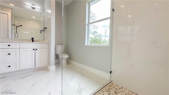 bathroom featuring vanity, toilet, and a shower