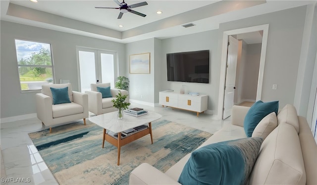 living room featuring french doors and ceiling fan