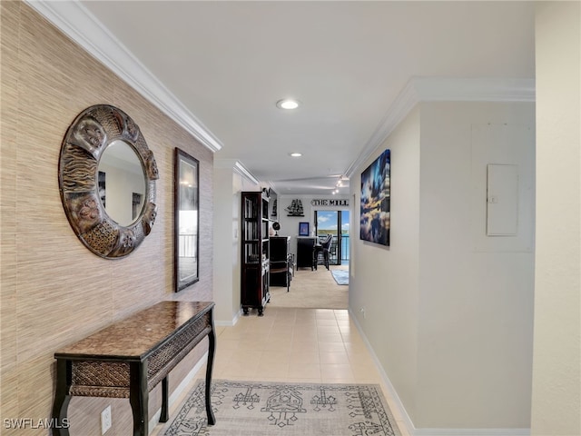 hallway featuring light tile patterned floors and crown molding