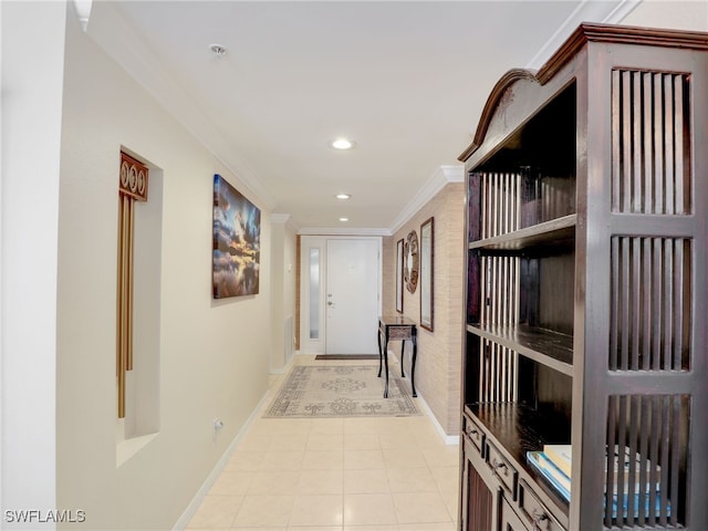 hall with ornamental molding and light tile patterned flooring