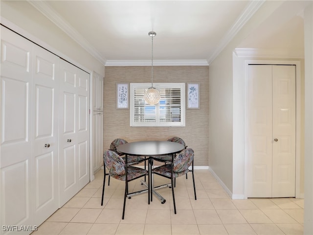 tiled dining space featuring ornamental molding and a chandelier