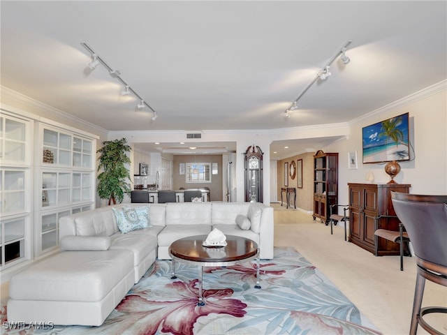 carpeted living room with track lighting and crown molding