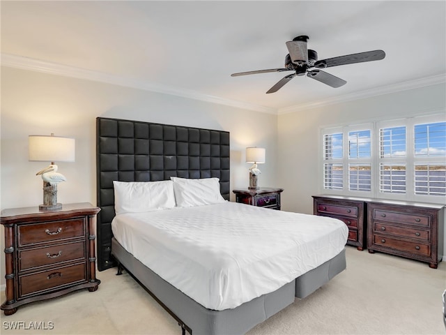 bedroom featuring light colored carpet, ceiling fan, and crown molding