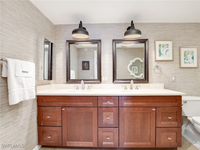 bathroom featuring toilet and vanity