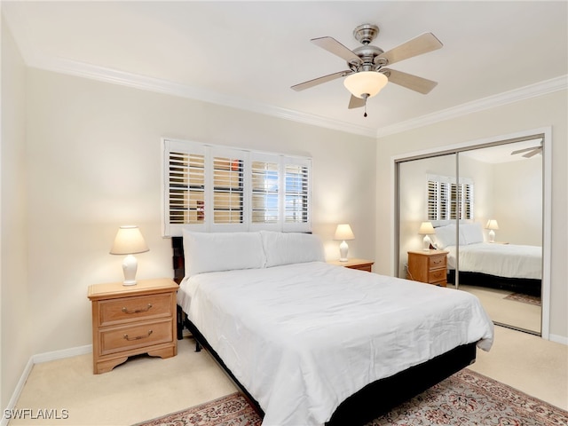 carpeted bedroom with a closet, ceiling fan, and crown molding