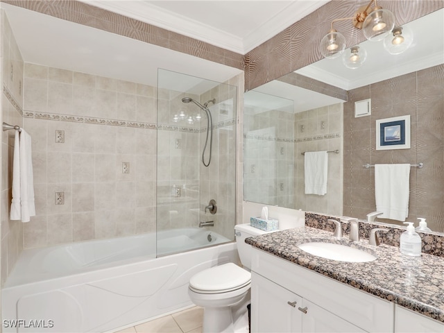 full bathroom with tile patterned floors, crown molding, vanity, toilet, and tiled shower / bath