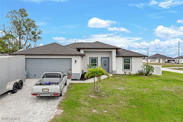 view of front of house featuring a garage and a front yard