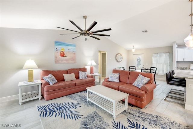 living room featuring ceiling fan, light hardwood / wood-style flooring, and lofted ceiling