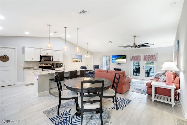 dining space featuring ceiling fan, light hardwood / wood-style flooring, and lofted ceiling