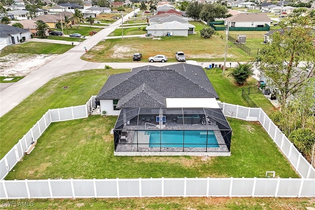 exterior space featuring glass enclosure and a lawn