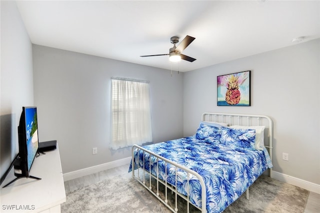 bedroom featuring wood-type flooring and ceiling fan