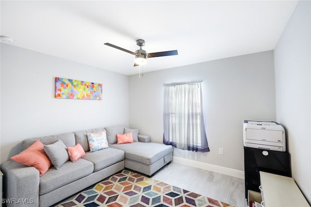 living room with ceiling fan and light wood-type flooring