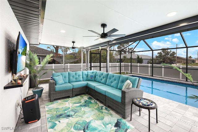 view of patio with a lanai, an outdoor hangout area, ceiling fan, and a fenced in pool