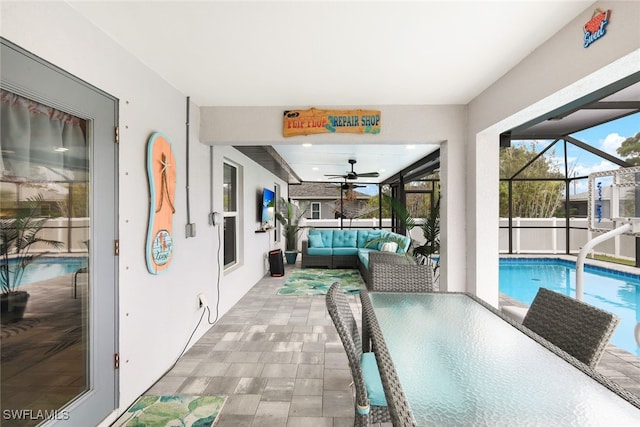 interior space featuring a lanai, ceiling fan, and an outdoor living space