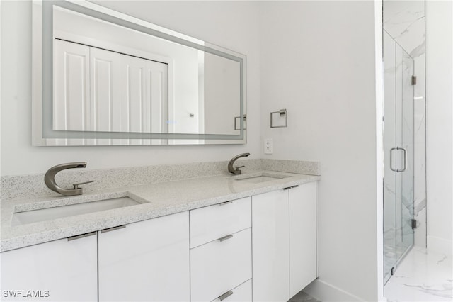 bathroom with vanity and a shower with shower door