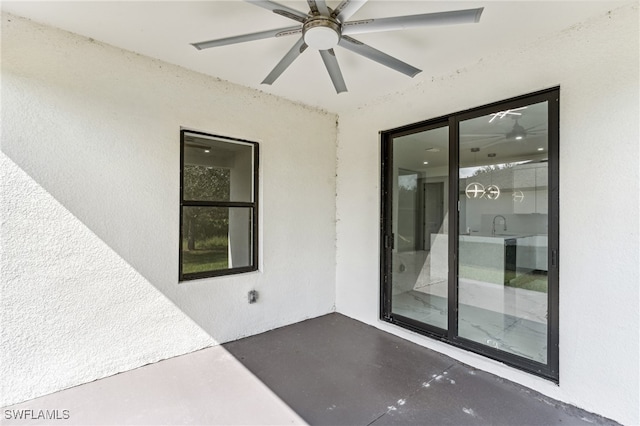 doorway to property featuring a patio area and ceiling fan