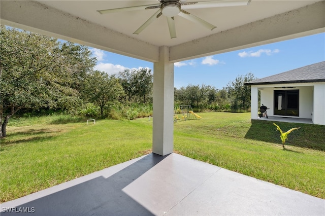 view of patio / terrace featuring ceiling fan and a playground