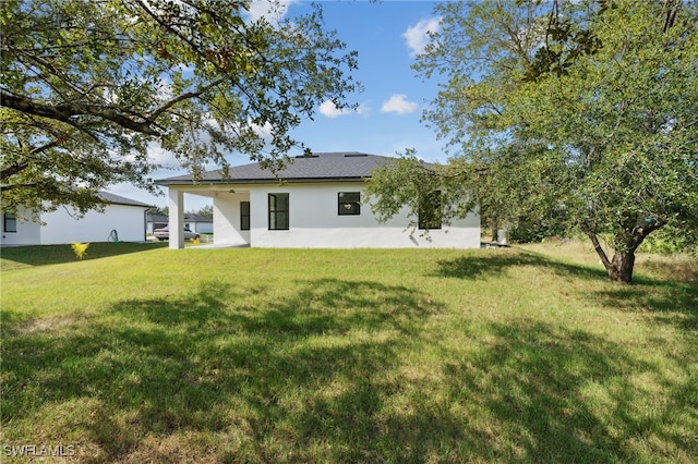 rear view of house with a yard