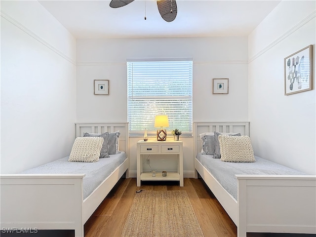 bedroom featuring hardwood / wood-style floors and ceiling fan