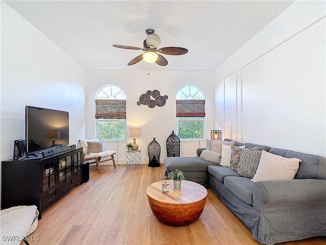 living room featuring light hardwood / wood-style floors, a wealth of natural light, and ceiling fan