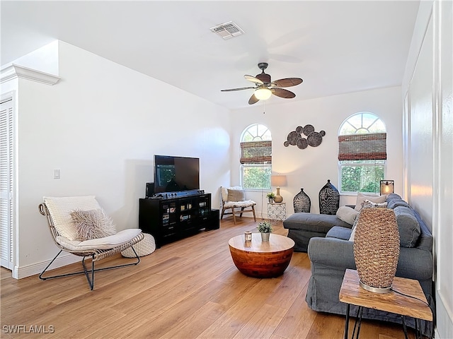 living room featuring ceiling fan and light wood-type flooring