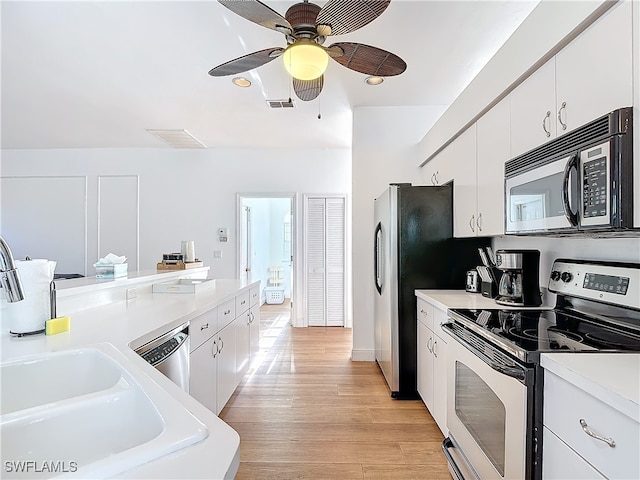 kitchen with appliances with stainless steel finishes, light hardwood / wood-style flooring, white cabinetry, and ceiling fan