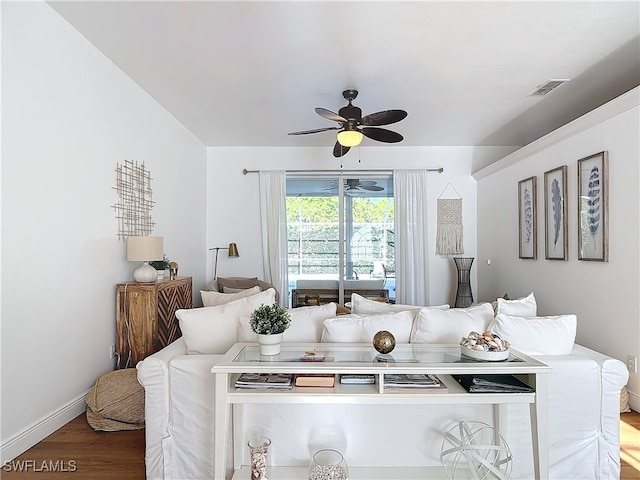 living room with wood-type flooring and ceiling fan