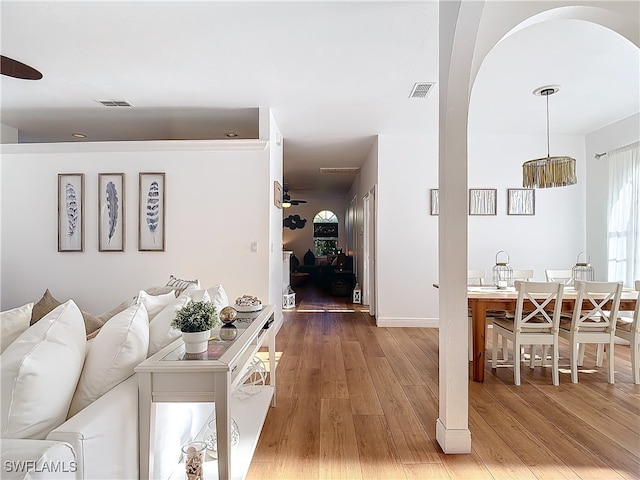 living room with hardwood / wood-style flooring and ceiling fan