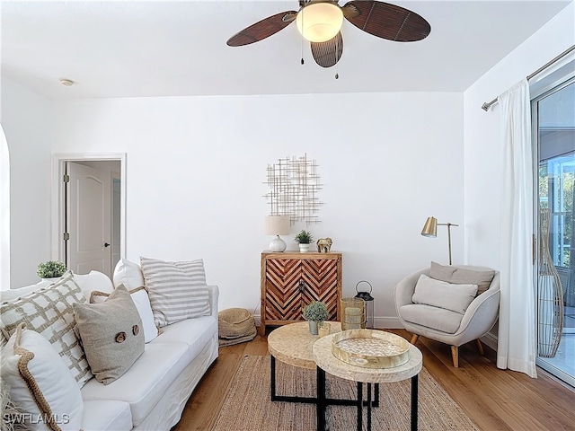 living room featuring hardwood / wood-style flooring and ceiling fan