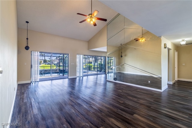 unfurnished living room with ceiling fan, high vaulted ceiling, a wealth of natural light, and dark hardwood / wood-style floors