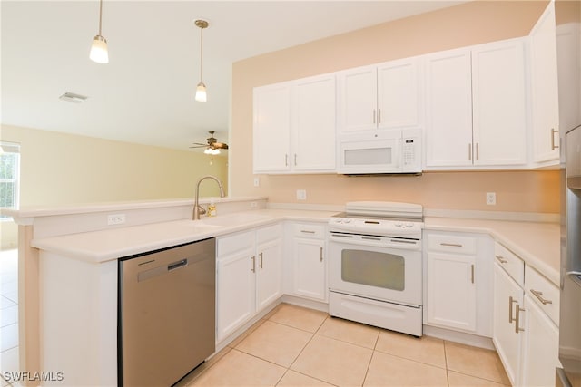 kitchen with sink, white appliances, decorative light fixtures, and white cabinets