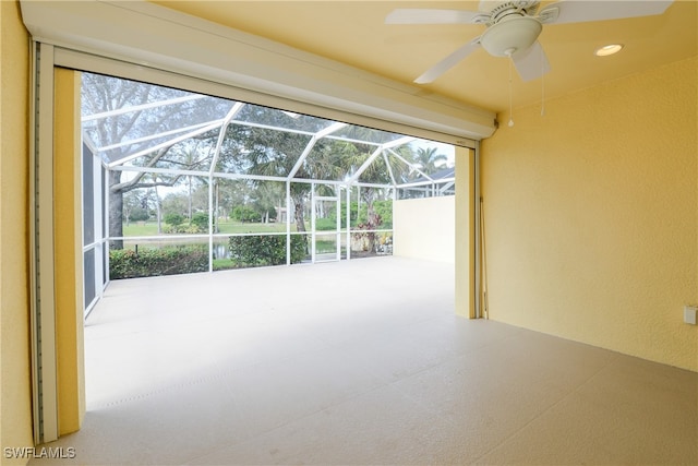 view of patio featuring glass enclosure and ceiling fan