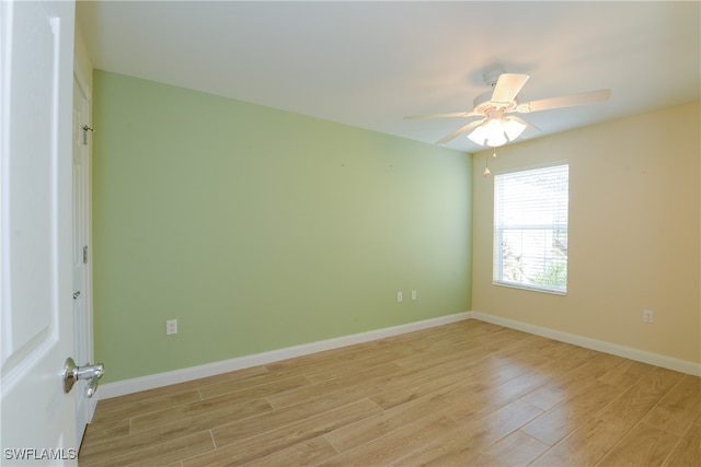 spare room featuring light hardwood / wood-style floors and ceiling fan