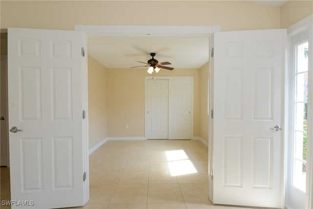 spare room with light tile patterned flooring and ceiling fan