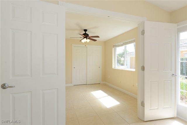 unfurnished bedroom featuring ceiling fan and light tile patterned floors