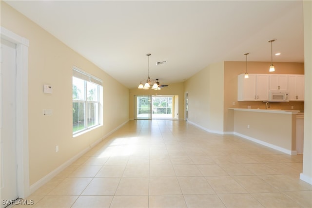 interior space with light tile patterned floors and a notable chandelier