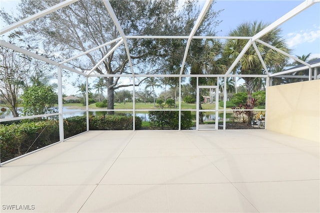 view of patio / terrace with a lanai and a water view