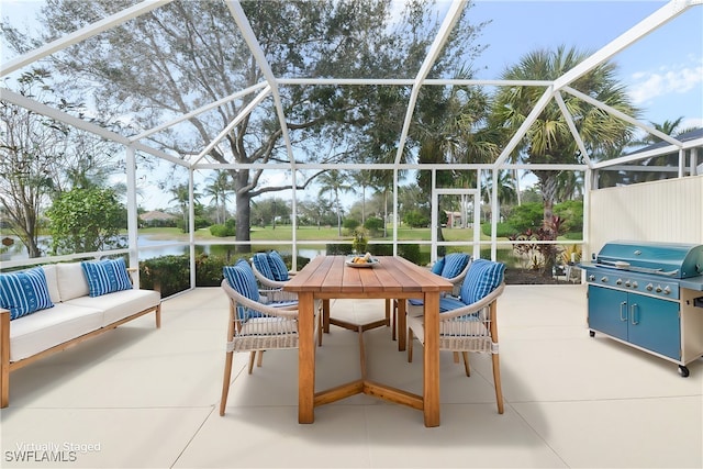 view of patio / terrace with a lanai, a grill, a water view, and an outdoor hangout area